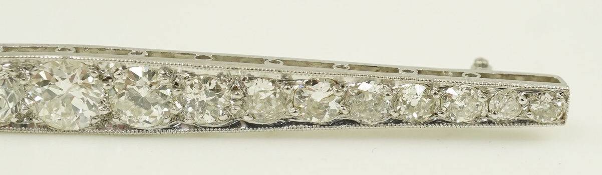 A 1920's platinum? and nineteen millegrain set graduated diamond bar brooch, 59mm, gross weight 4.6 grams. Condition - fair to good